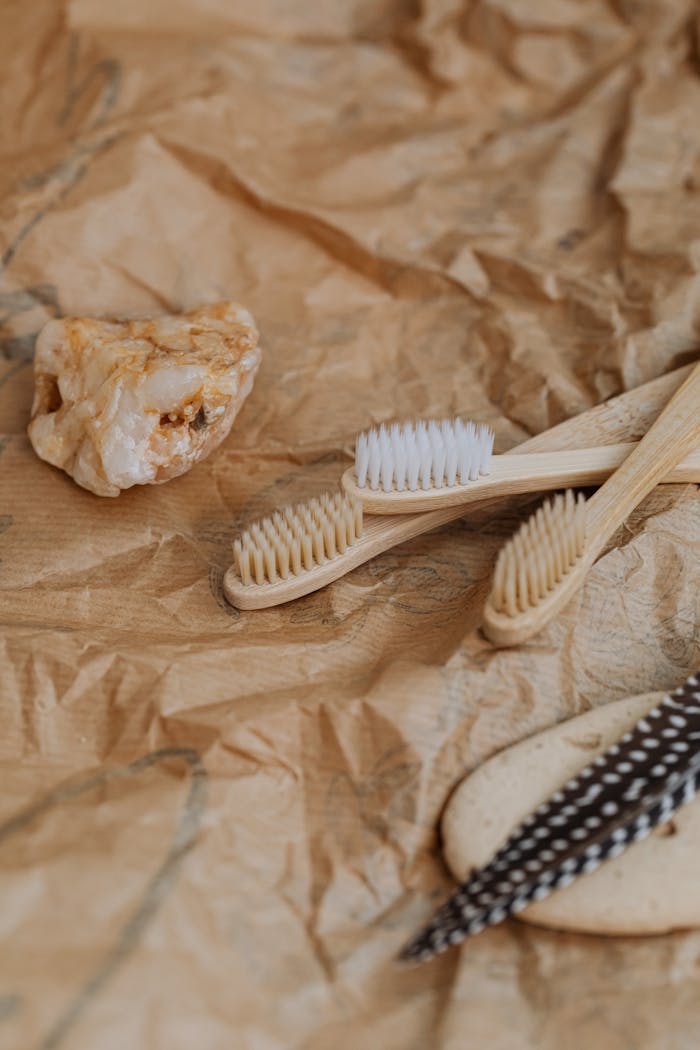 Wooden toothbrushes on brown textured paper, promoting zero waste lifestyle.