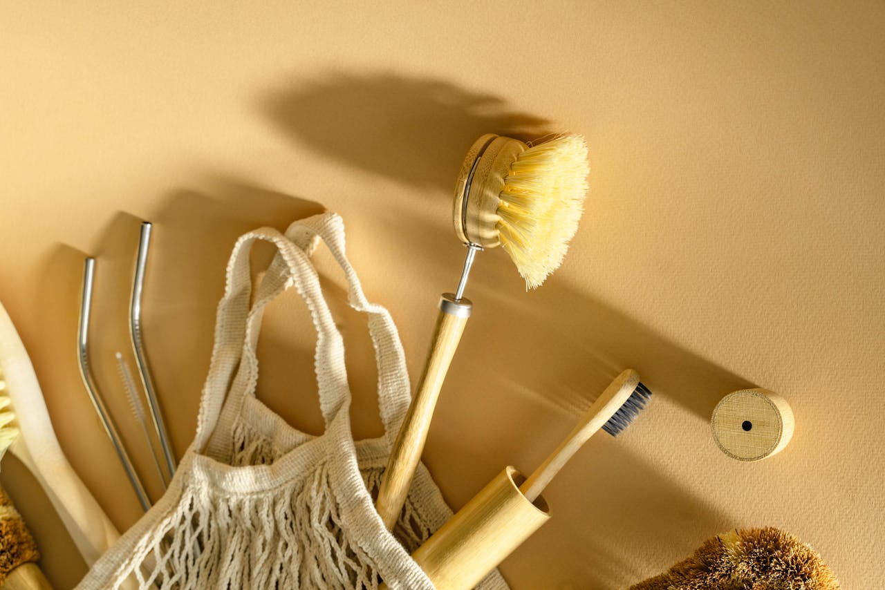 A minimalist still life of eco-friendly bathroom accessories on a beige background.