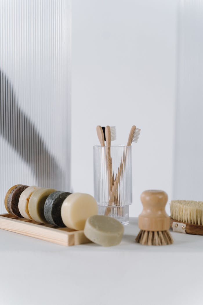 Stylish collection of eco-friendly bathroom essentials including wooden toothbrushes and natural soaps.