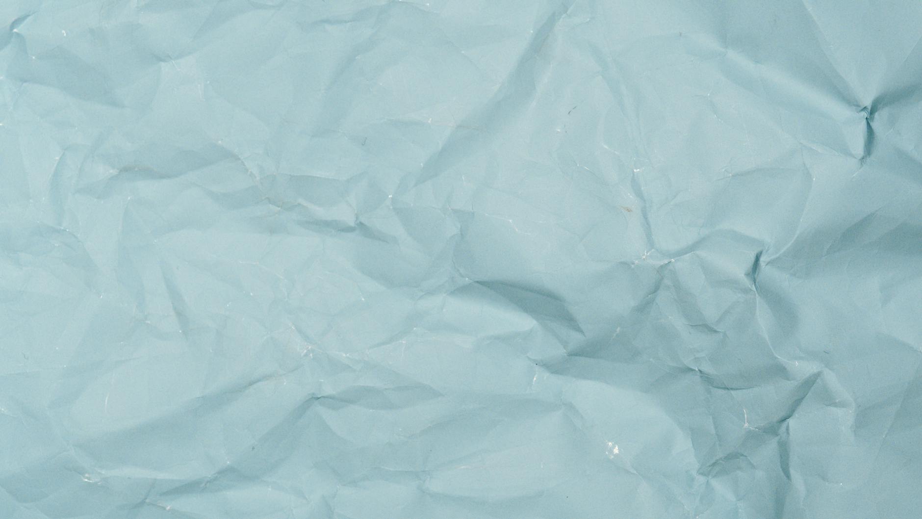 Detailed crumpled blue paper background perfect for design projects needing textured material.